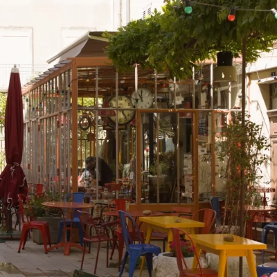 Sunny cafe terrace with colorful bistro chairs in Saint-Rémy-de-Provence.